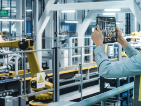 Create a professional image for a blog post about IoT in the workplace. Show a factory worker