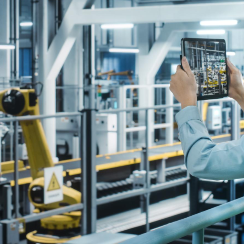 Create a professional image for a blog post about IoT in the workplace. Show a factory worker